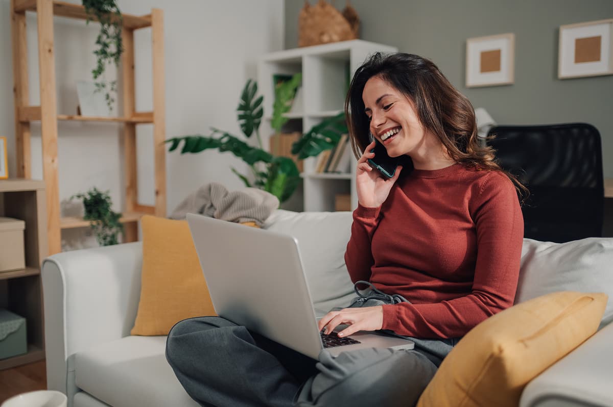 happy-freelancer-woman-working-from-home-talking